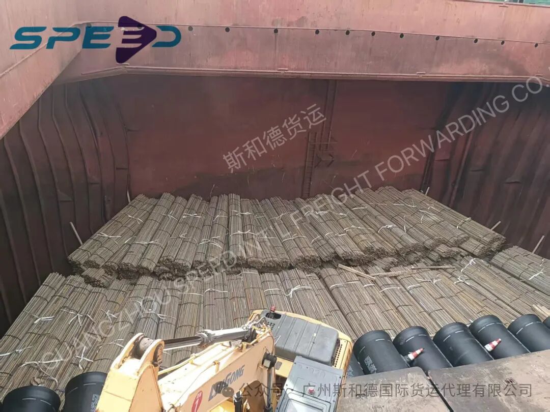 Bundles of scaffolding steel pipes securely stowed inside the vessel hold